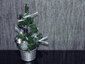 A small decorative Christmas tree in a silver pot Royalty Free Stock Photo