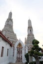 A small decorative tree grows near the entrance to the temple of Wat Arun Royalty Free Stock Photo