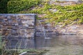 A small decorative waterfall in the garden. Landscape design Royalty Free Stock Photo