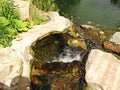 A small decorative waterfall in the garden. Landscape design Royalty Free Stock Photo