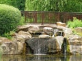 A small decorative waterfall in the garden. Landscape design Royalty Free Stock Photo