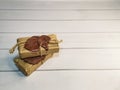 Small delivery box tied with twine with a wax seal on wooden boards