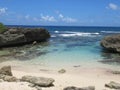 A small deserted beach, turquoise sea and blue sky Royalty Free Stock Photo