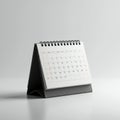 A small desk calendar with a black triangular stand and a spiral-bound top