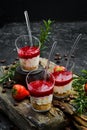 Small dessert: strawberries, cream and nuts in plastic cups.