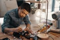The small details always play a major role. a handsome young boy building a robotic toy car at home.