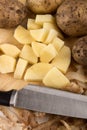 Into small dice cut organic potatoes Royalty Free Stock Photo