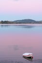 Small dinghy on beach at sunset