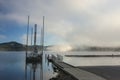 Small dock and barge by lake.