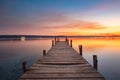 Small Dock or wooden pier and the sea lake at sunset Royalty Free Stock Photo