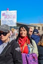 Small dog in Pink hat yawning surrounded by people in hats at Womens march in Tulsa Oklahoma 1-20-2017 Royalty Free Stock Photo