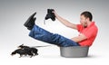 Small dogs pull the man in a basin, humor concept
