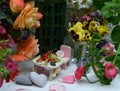 Small dollhouse furniture with beautiful flowers, decorations and berries. Fairies in the garden