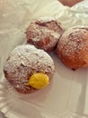 small donuts, donuts with egg cream, yellow custard cream, donuts sprinkled with powdered sugar