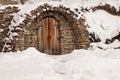 Small door made of stones during winter time Royalty Free Stock Photo