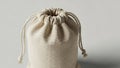 A small drawstring bag made of beige canvas fabric is depicted Royalty Free Stock Photo