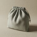 A small drawstring pouch made from textured, light gray fabric sits on a matching Royalty Free Stock Photo