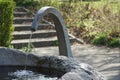 A small drinking well of stone and metal, a source of drinking water accessible for free in public place