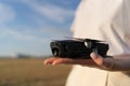 A small drone in hands. Electronic gadget for work and hobby. Quadcopter operator with device Royalty Free Stock Photo