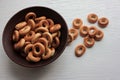 Small dry bagels for kids in brown ceramic bowl on white wooden background. Healthy snack Royalty Free Stock Photo