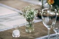 Small dry flowers bush in vase on decorated vintage style table Royalty Free Stock Photo