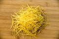 Small dry pasta noodles on wood background Royalty Free Stock Photo