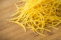 Small dry pasta noodles on wood background Royalty Free Stock Photo