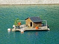 A small duck lodge on a artifical lake Ganglesee or Gaenglesee and in the Saminatal alpine valley - Steg, Liechtenstei