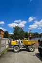 Small dump truck or dumper on a urban construction site. Sunny summer day, no people