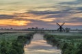 Small Dutch Windmill and field sunrise at Zaanse Schans Village, Netherlands Royalty Free Stock Photo