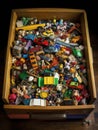 A small e bin the top half hidden by its own contents of discarded toys.. AI generation