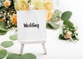 Small easel with text on creative background with roses Royalty Free Stock Photo
