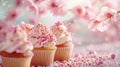 small Easter cupcake and some sprinkles with pink blossoms, soft light background Royalty Free Stock Photo