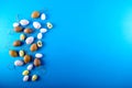 Small easter eggs different size on blue background with copy space. Royalty Free Stock Photo