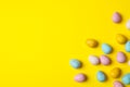 Small Easter eggs on yellow background Royalty Free Stock Photo