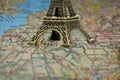 Small Eiffel tower Paris souvenir closeup on map Royalty Free Stock Photo
