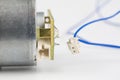 Small electric motor on a white workshop table. Electric drive u Royalty Free Stock Photo