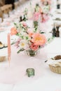 A small elegant bouquet of an assortment of fresh flowers adorns the dining table at the wedding Royalty Free Stock Photo