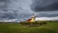Historic church in Iceland countryside under stormy sky