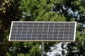 Small elongated solar panel used to power LED traffic sign mounted on top of strong metal pole in local public park Royalty Free Stock Photo