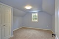 Small empty blue bedroom accented with vaulted ceiling Royalty Free Stock Photo