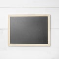 Small empty chalkboard on wooden texture