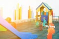 Small Empty Children Playground of a Kindergarten in a European City. Colorful Wooden House Seesaw Slide Soft Rubber Ground