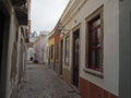 Small empty street with flaking colour houses in Naples