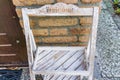 Small empty weathered white wooden cabinet rack saying welcome background texture