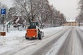 Small excavator bobcat working on the street