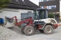 Small excavator digging gravel on a construction site