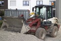 Small excavator digging gravel on a construction site