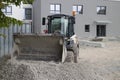 Small excavator digging gravel on a construction site