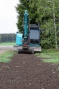 Small excavator in garden Royalty Free Stock Photo